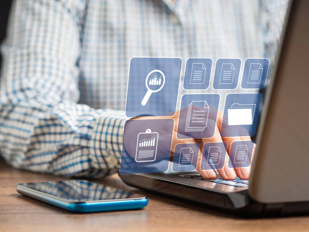 istock Businessman working at a laptop and digital documents on a virtual screen 1586655376