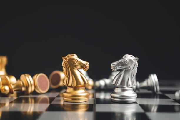 istock Chess pieces on board game planning and competition on black background 1586655538