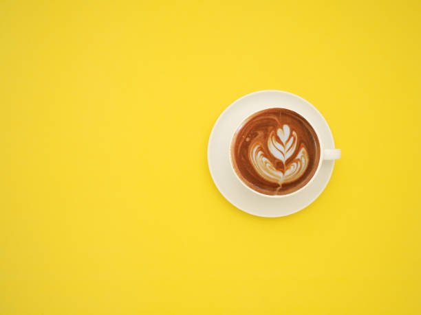 istock Top view of a fresh coffee cup over a yellow background 1586655588