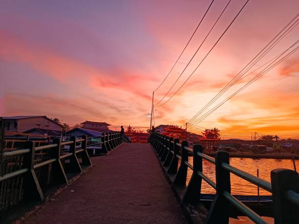 istock Small Bridge at Sunset with Reflection on the River of Kakap 1586655627