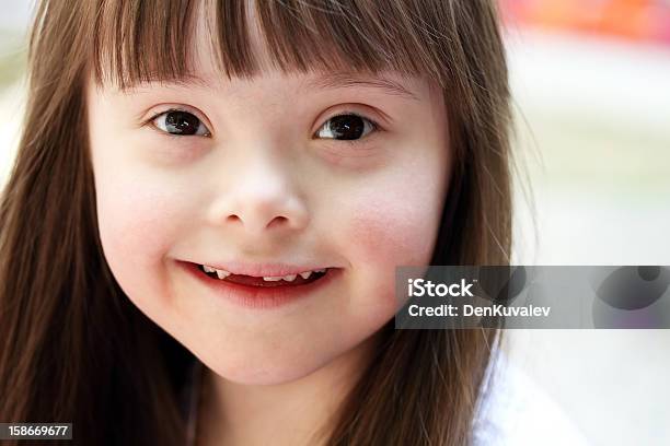 Portrait Of A Brown Haired Infant Girl Stock Photo - Download Image Now - Child, Down Syndrome, Childhood