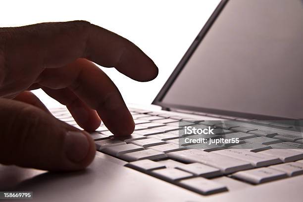 Silhouetted Image Someone Typing On Laptop Computer Symbol Shad Stock Photo - Download Image Now