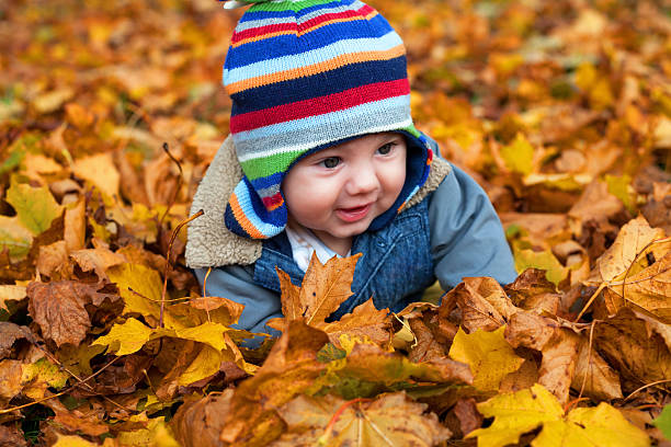 istock baby boy in autumn leaves 158669882