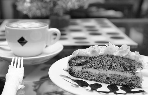 istock Cappuccino and poppy seed cake on cafe table outdoors. 158674822