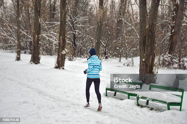 Winter Run Woman In Snowy Park Stock Photo - Download Image Now - Active Lifestyle, Activity, Adult