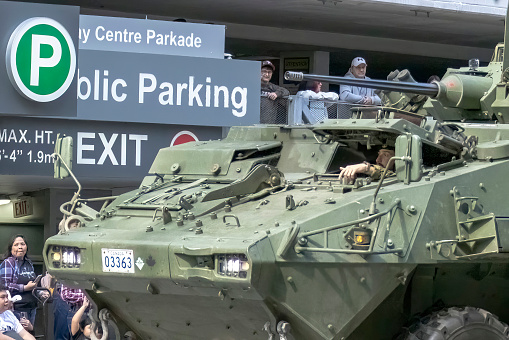 Calgary, Alberta, Canada. July 7, 2023. A close up to a Canadian Armed Force armoured main battle tank with a soldier in at a public festival parade.