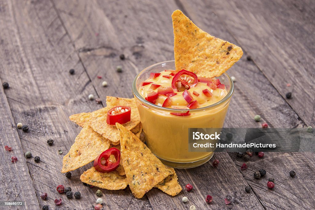 Fresh Cheese Sauce with Nachos Fresh Cheese Sauce with Nachos on wooden background Appetizer Stock Photo