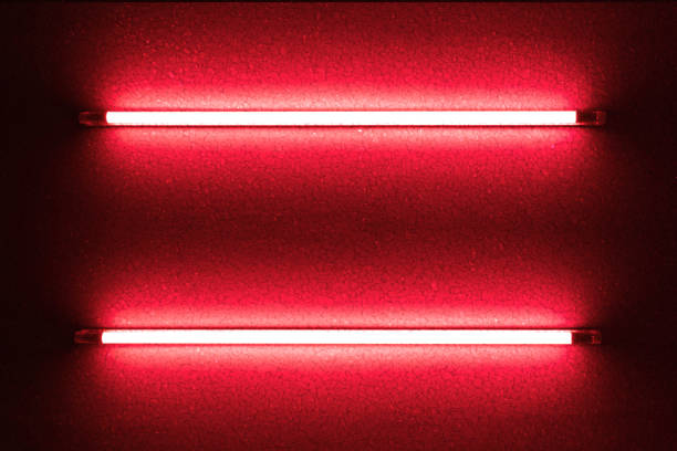 istock Two red neon bulbs on stone wall. Background texture of empty black stone wall with red neon light lamp style glow. 1586808941