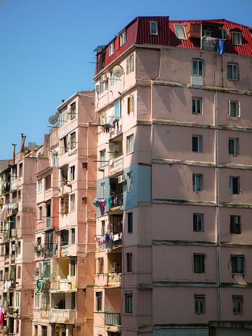 Old residential multistory building under the bright sunlight