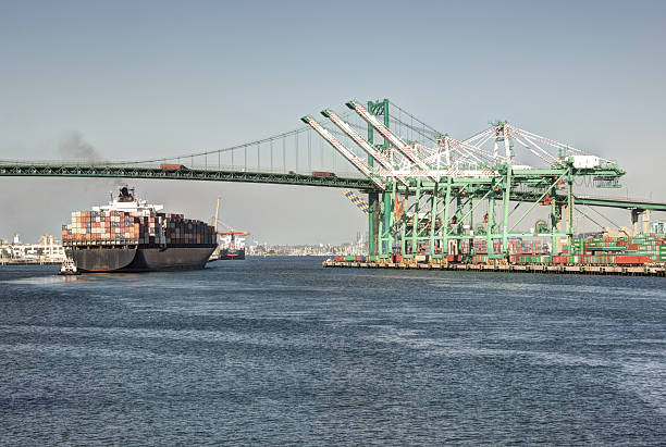 Shipping Industry Port of Los Angeles Huge container ship under the historic Vincent Thomas Bridge in San Pedro (Port of Los Angeles) san pedro los angeles photos stock pictures, royalty-free photos & images