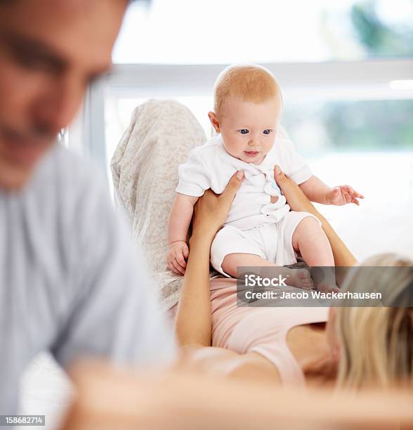 Safe And Secure In His Mothers Arms Stock Photo - Download Image Now - Adult, Affectionate, Baby - Human Age