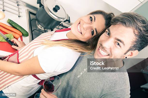 Young Couple Cooking In The Kitchen Stock Photo - Download Image Now - 20-24 Years, Adult, Adults Only