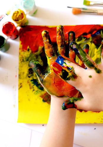 Child painting by finger hand . Ideas for drawing with finger paints. Children development . The concept of a happy childhood