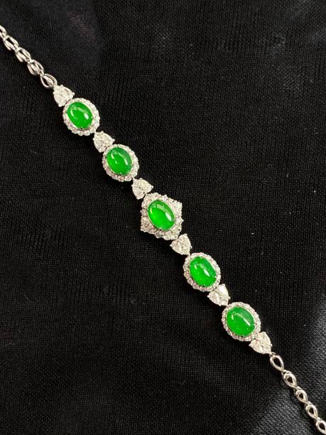 istock Silver bracelet featuring a green Jade stones on a black background 1586856165