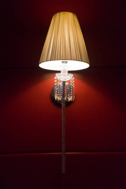 istock Lamp wall mounted lighting on red colored painted wall 1586869127