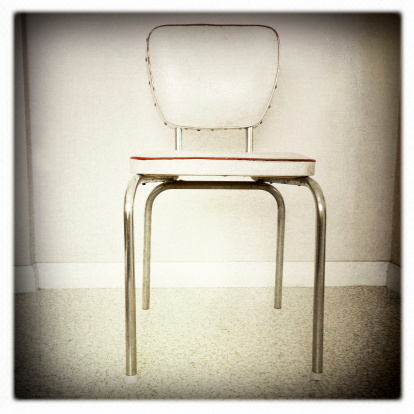 Old retro chair in room.