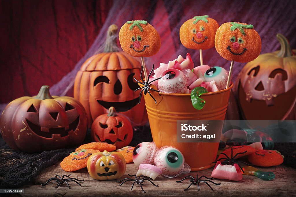 Festive picture of carved pumpkins and Halloween sweets Halloween sweets for Halloween party Flavored Ice Stock Photo