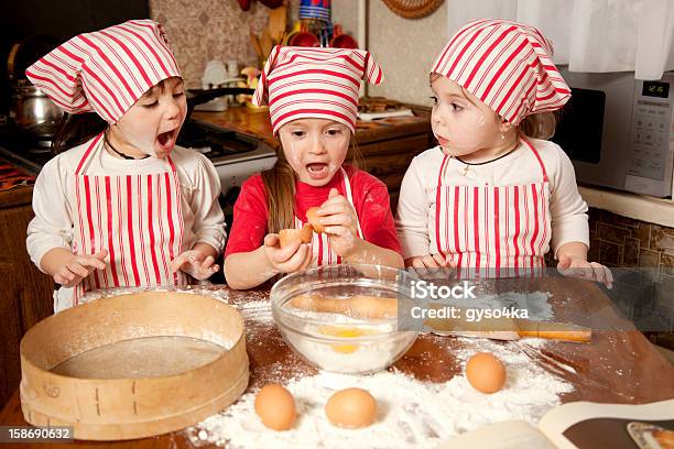 Three Little Chefs Enjoying In The Kitchen Stock Photo - Download Image Now - 4-5 Years, Apron, Baking