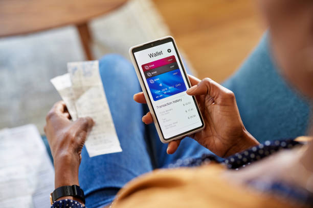 Black woman checking digital wallet on smartphone stock photo