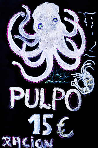 Octopus suggestion, chalk drawing on black board . Restaurant menu in spanish language. . Ourense, Galicia, Spain. Tourism, Camino de Santiago.