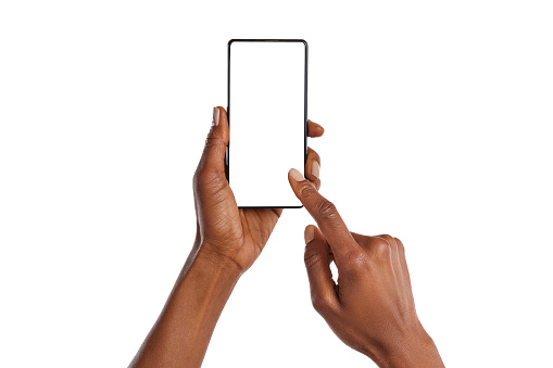 Close up of african american woman hands showing smartphone against white background. Black woman hands touching blank empty screen of cellphone. Close up of female hands using app on mobile phone isolated.