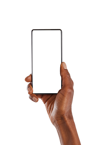 Close up of female african hand showing smartphone against white background. African american woman hand holding cellphone with blank screen. Closeup of black hand holding smartphone with empty screen isolated on white background.