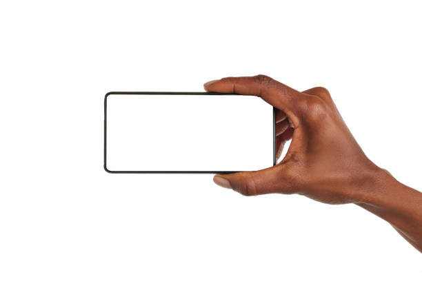 istock Black woman hand holds smart phone horizontally 1586918489
