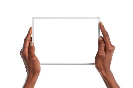 Close up of african american woman hands showing digital tablet against white background with empty screen. Black girl hands holding digital tablet with blank screen isolated.