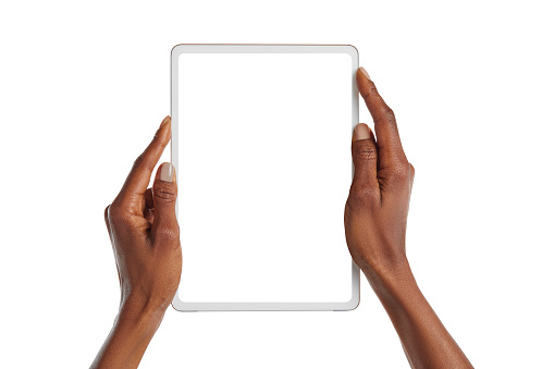 Close up african american woman hands showing digital tablet against white background. Female black hands holding digital tablet vertically with empty screen isolated. Girl holding modern digital device with blank screen.