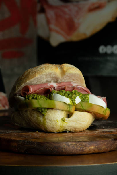 istock Sandwich with cooked ham tomato mozzarella and basil 1586919530