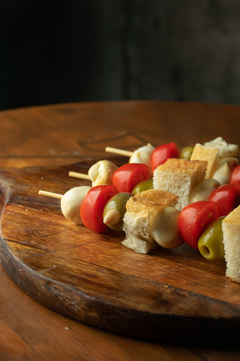 Skewers of mozzarella, tomato, olives and focaccia