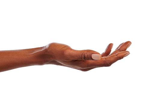 Close up of african american woman hand with palm facing upwards with copy space. Woman hand showing empty hand isolated against white background. Empty open female palm ready for your beauty product.