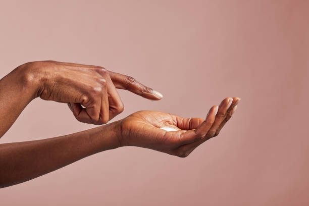istock African american beauty hands with moisturizing cream on palm 1586922271