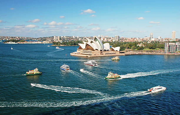 Sydney Cove, Australia Sydney Opera House with ferrys in foregournd, taken from Harbour bridge sydney harbor photos stock pictures, royalty-free photos & images