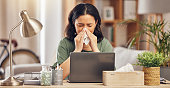 Remote work from home, sneeze and woman with a laptop, virus and illness with disease. Female person, freelancer and entrepreneur blowing her nose, covid and flu with online consultation with doctor