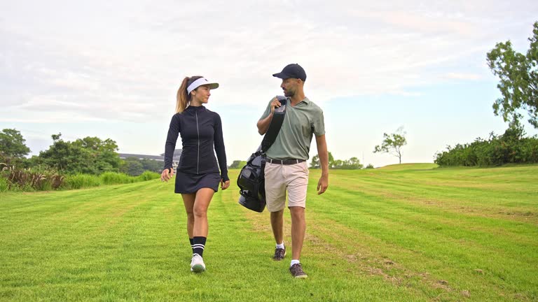 Sports Man and Athletic Woman Walk at Golf Course with Clubs and Balls in Bag. Happy Couple of Caucasian People Ready to Play Game with Putter. Modern Concept of Professional Male and Training Female