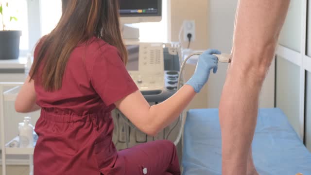 A close-up ultrasound examination of the leg veins of a sick patient. Treatment of varicose veins