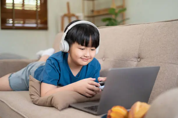 Photo of boy lying on the sofa on vacation.