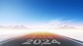 New year 2024,  straightforward road trip travel and future vision of asphalt road at sunrise. Concept of planning, challenge, goal, and new year resolution