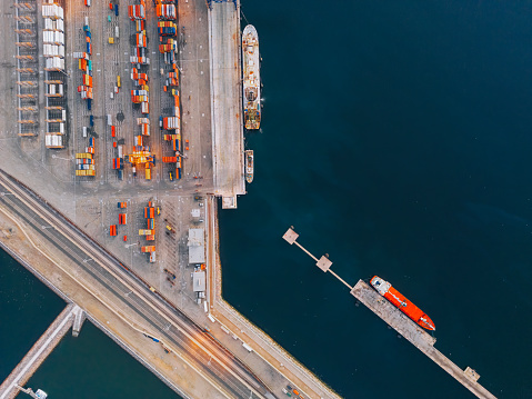 sea port in export and import business and logistics. Shipping cargo to harbor by crane. Water transport International. Aerial view and top view