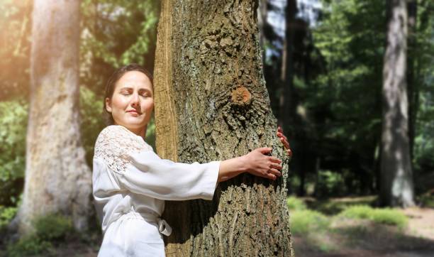 istock Symbol image: Young woman doing foresth bathin (Shnrin Yoku), natural therapy from Japan (Model released) 1587004557