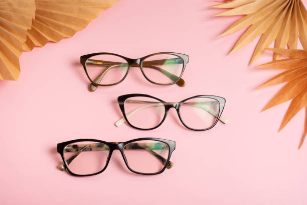 istock Eyeglasses on pink background. Optical store, vision test, stylish glasses concept 1587026280