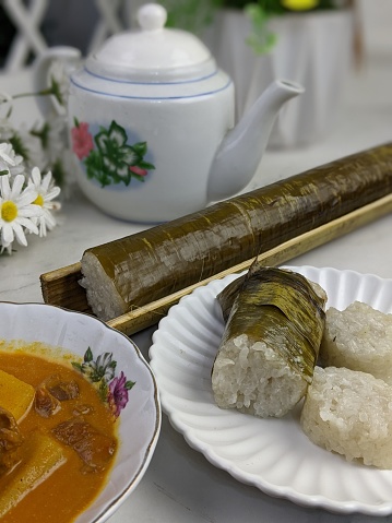 Glutinous rice is wrapped with lerek or banana leaf encased in bamboo culm and cooked in open fire / Lemang / A must have in every traditional Malay household, eaten with beef or chicken rendang