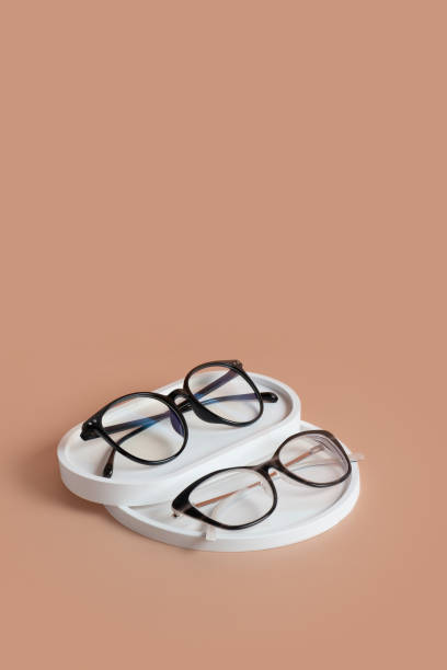 istock Podiums with eyeglasses on colored background. Optical store, vision test, stylish glasses concept top view, flat lay 1587027050