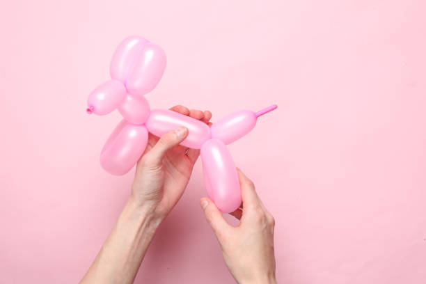 Hand holding dog balloon