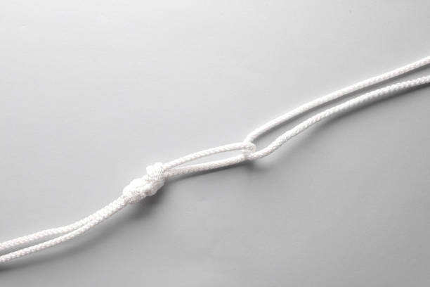 istock Rope with a knot on gray background 1587027941