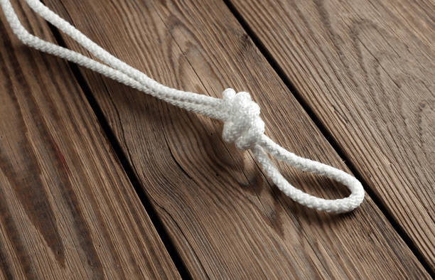 istock Rope with a knot on a wooden table 1587027943