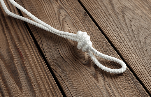 Rope with a knot on a wooden table