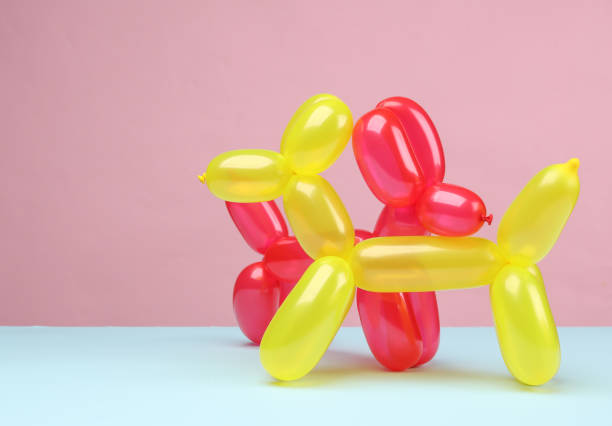 istock Two balloon dogs on a blue pink background 1587027978
