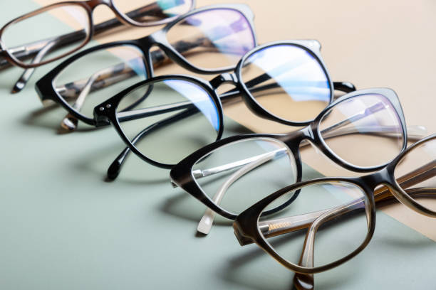 istock Stylish eyeglasses on colored background. Optical store, vision test, stylish glasses concept. 1587028479